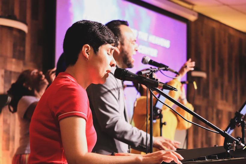 People with hands raised in worship